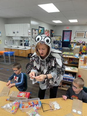 Cathy Black, from Orena Humphreys Pubic Library, working with pre-school students to make an owl hand puppet during story time at the Whitwell Head Start center
